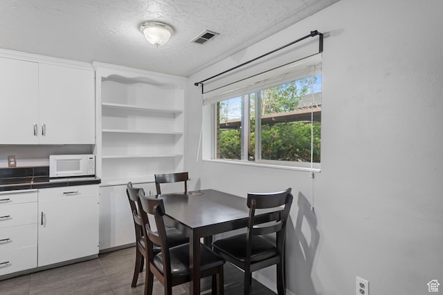 639 N University Ave Unit 2, Provo, UT 84601 - tiled dining room featuring a textured ceiling and visible vents