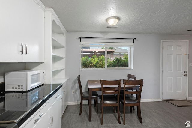 639 N University Ave Unit 2, Provo, UT 84601 - dining space with baseboards, a textured ceiling, wood finished floors, and visible vents