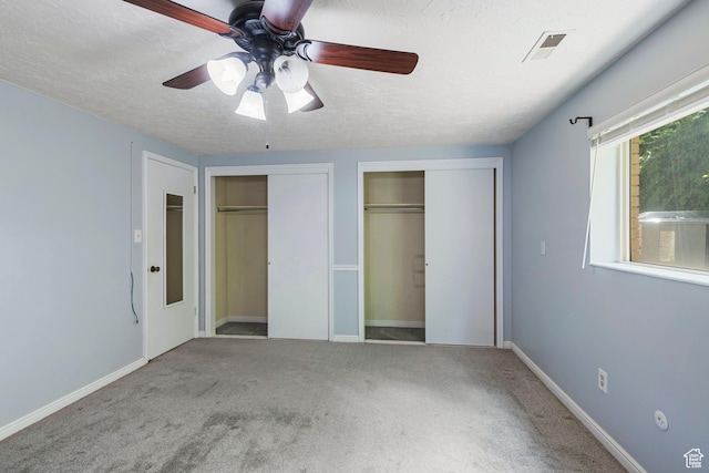 639 N University Ave Unit 2, Provo, UT 84601 - unfurnished bedroom with carpet floors, a textured ceiling, multiple closets, a ceiling fan, and visible vents