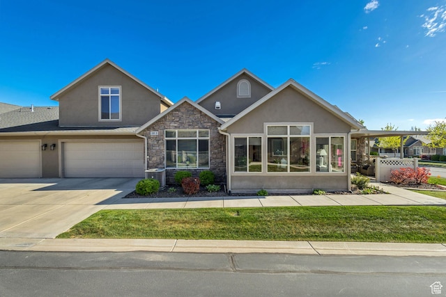 1889 S 910 W Unit B, Syracuse, UT 84075 - view of front of home featuring central AC, an attached garage, stucco siding, and stone siding