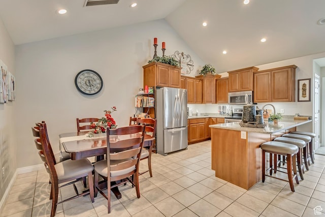 1889 S 910 W Unit B, Syracuse, UT 84075 - kitchen with appliances with stainless steel finishes, brown cabinets, a peninsula, and high vaulted ceiling