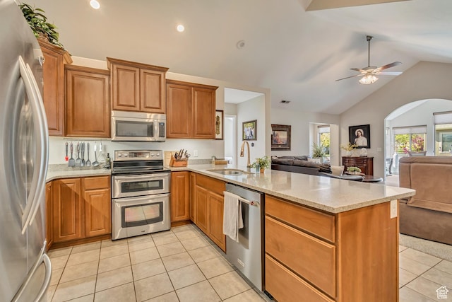 1889 S 910 W Unit B, Syracuse, UT 84075 - kitchen with a peninsula, light tile patterned flooring, open floor plan, a sink, and stainless steel appliances