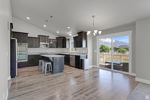 1350 S 849 W Unit 17D, Springville, UT 84663 - kitchen featuring appliances with stainless steel finishes, dark brown cabinets, a chandelier, a kitchen island, and baseboards