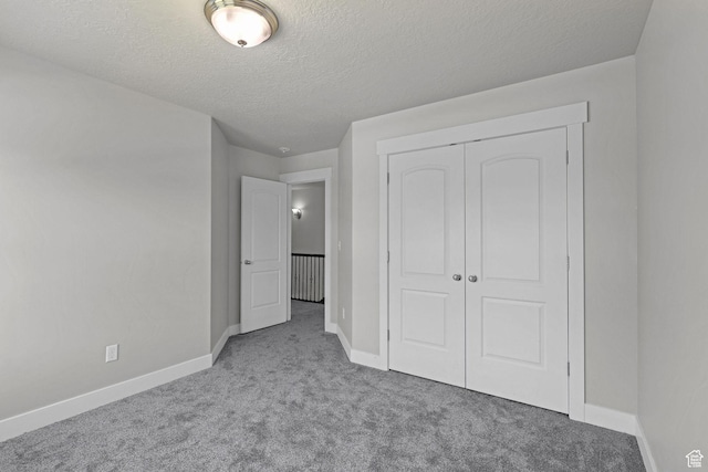 1350 S 849 W Unit 17D, Springville, UT 84663 - unfurnished bedroom featuring carpet, baseboards, a textured ceiling, and a closet