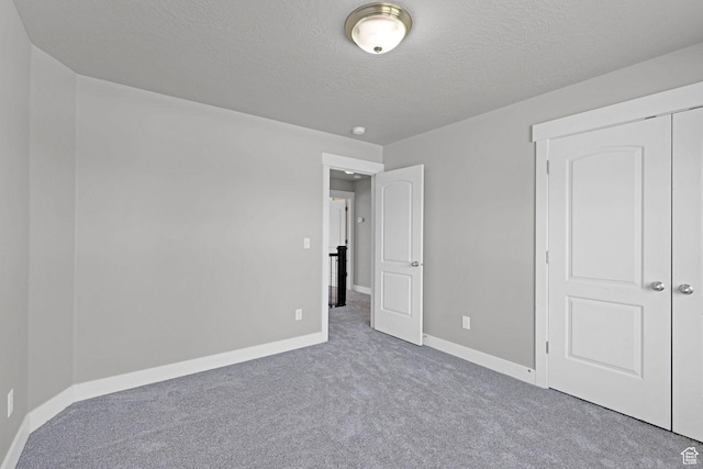1350 S 849 W Unit 17D, Springville, UT 84663 - unfurnished bedroom with carpet floors, baseboards, a textured ceiling, and a closet