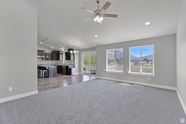 1350 S 849 W Unit 17D, Springville, UT 84663 - unfurnished living room with carpet floors, a chandelier, baseboards, recessed lighting, and ceiling fan