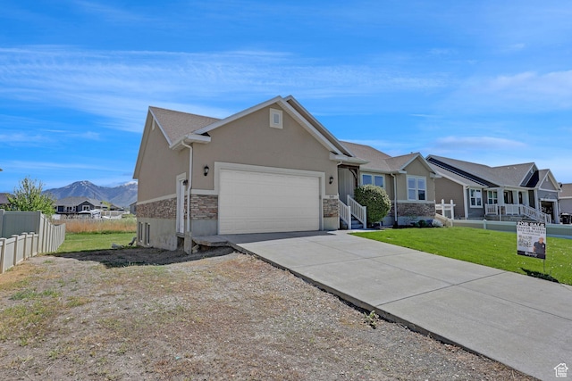 1350 S 849 W Unit 17D, Springville, UT 84663 - single story home featuring an attached garage, stucco siding, stone siding, concrete driveway, and a mountain view