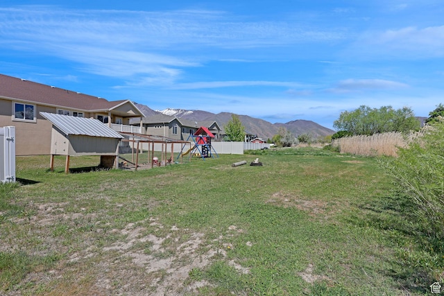 1350 S 849 W Unit 17D, Springville, UT 84663 - view of yard featuring a playground, exterior structure, a mountain view, and an outbuilding