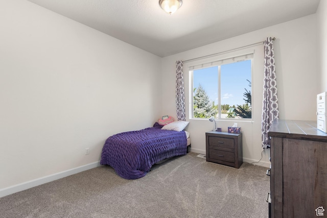 bedroom with baseboards and carpet flooring