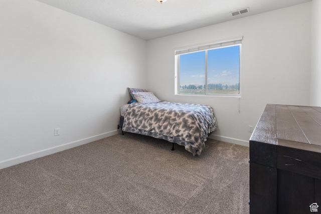 carpeted bedroom featuring baseboards and visible vents
