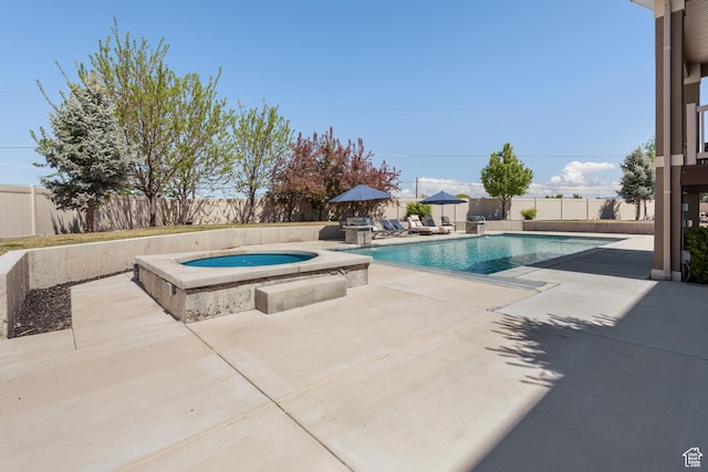 view of swimming pool featuring an in ground hot tub, a fenced in pool, a fenced backyard, and a patio area