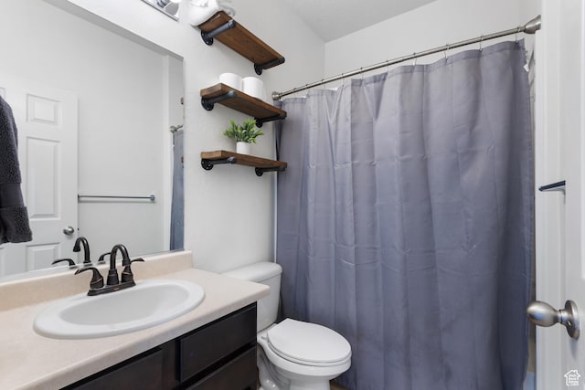 bathroom featuring vanity, a shower with shower curtain, and toilet