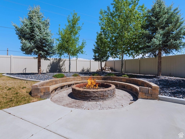 view of patio with a fenced backyard and an outdoor fire pit