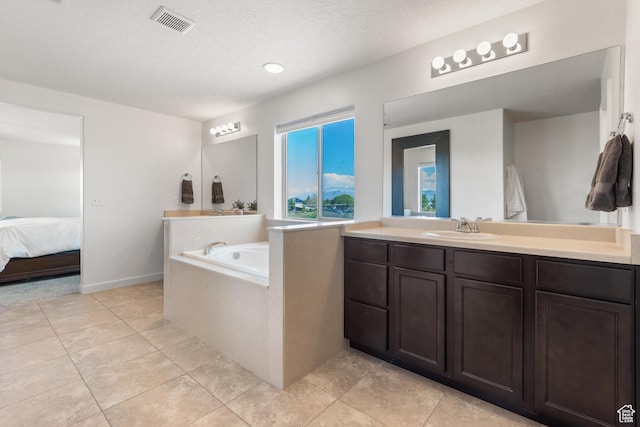 full bathroom with tile patterned flooring, ensuite bath, vanity, visible vents, and a garden tub