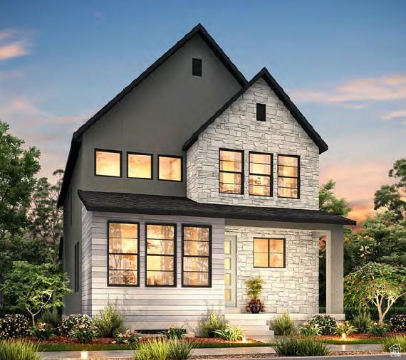 back of property featuring stone siding