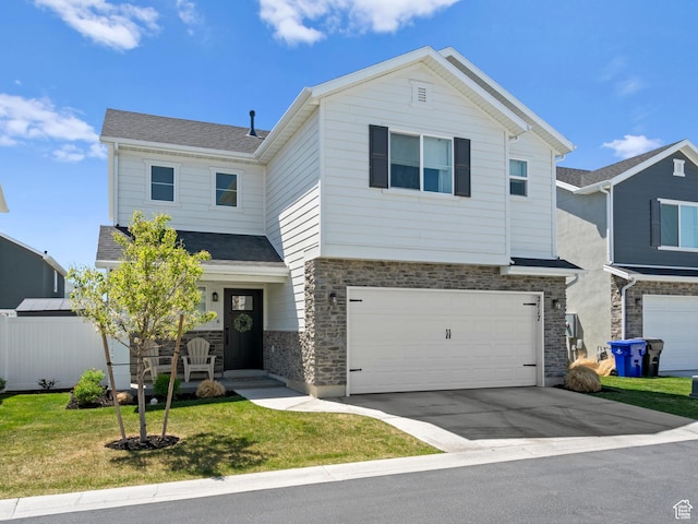 view of front facade featuring a front yard, a garage, concrete driveway, a shingled roof, and stone siding