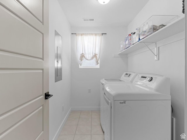 laundry room with laundry area, visible vents, light tile patterned flooring, baseboards, and washer and clothes dryer
