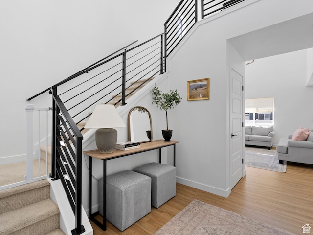 stairway with baseboards and wood finished floors