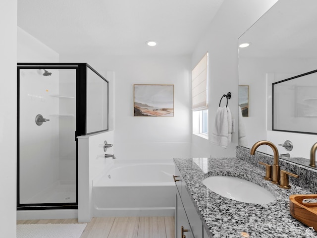 bathroom with vanity, a stall shower, recessed lighting, and a bath