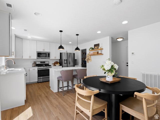 dining room featuring light wood-style floors, recessed lighting, and visible vents