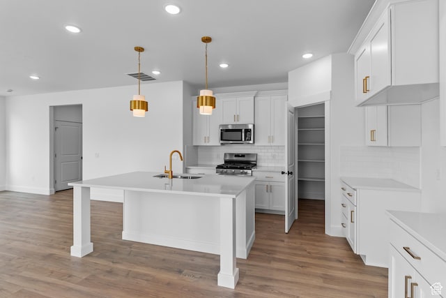 688 N 600 W Unit 104, Tremonton, UT 84337 - kitchen featuring stainless steel appliances, light countertops, tasteful backsplash, recessed lighting, and an island with sink