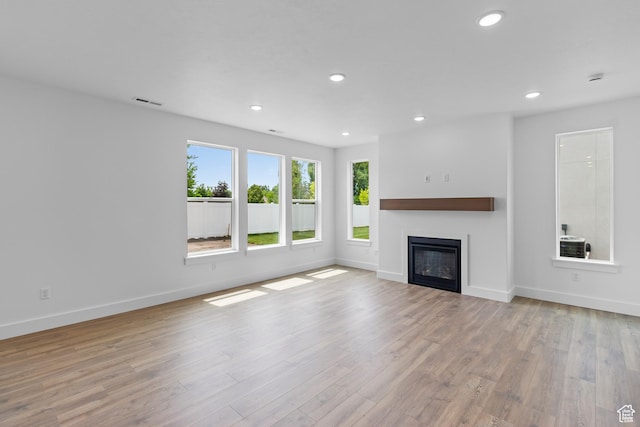 688 N 600 W Unit 104, Tremonton, UT 84337 - unfurnished living room featuring recessed lighting, wood finished floors, and a glass covered fireplace