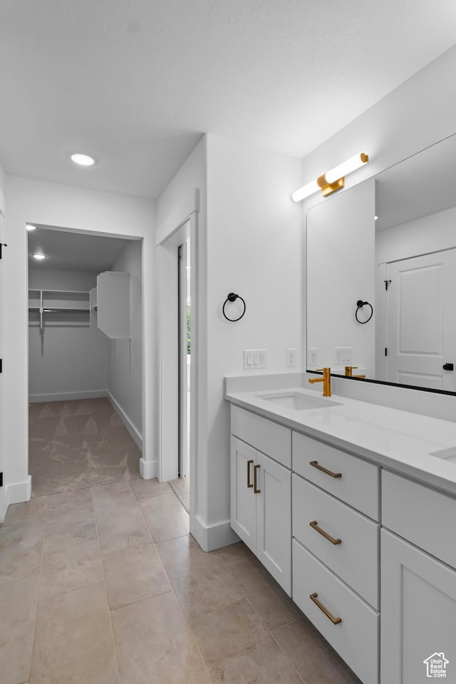 688 N 600 W Unit 104, Tremonton, UT 84337 - bathroom featuring double vanity, a spacious closet, recessed lighting, and tile patterned floors