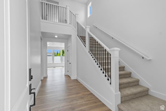 688 N 600 W Unit 104, Tremonton, UT 84337 - foyer entrance featuring stairs, wood finished floors, and a towering ceiling