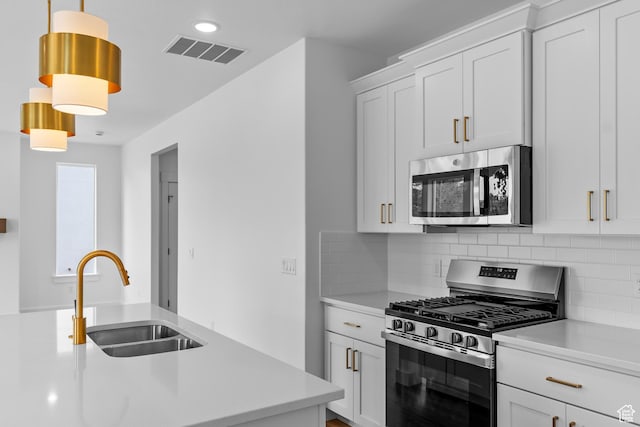 688 N 600 W Unit 104, Tremonton, UT 84337 - kitchen with stainless steel appliances, light countertops, decorative backsplash, white cabinetry, and recessed lighting