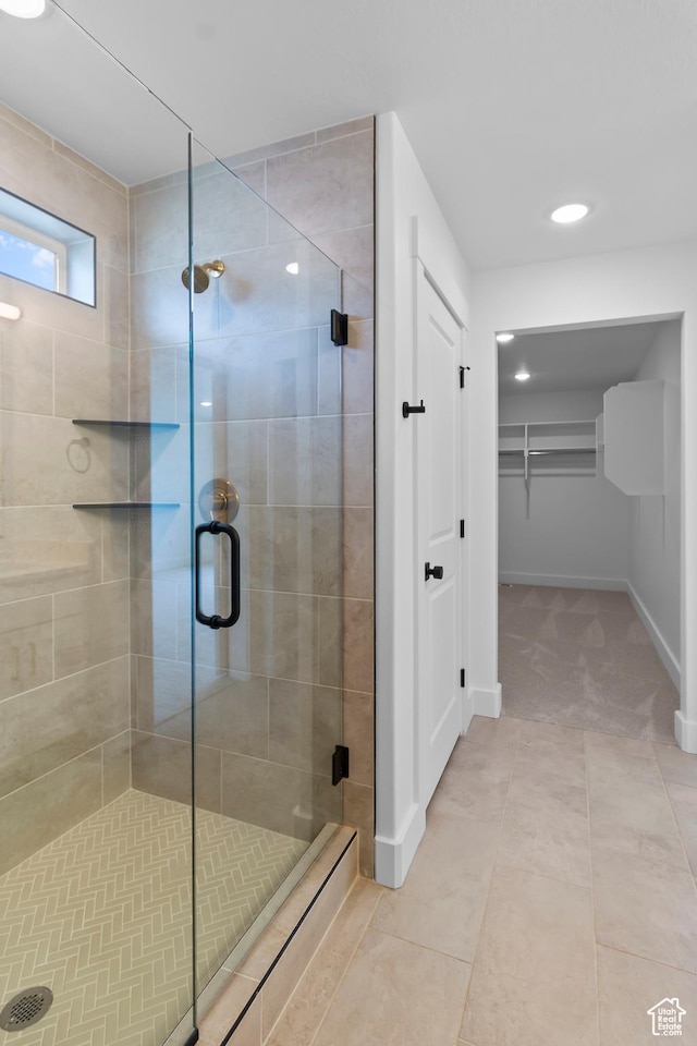688 N 600 W Unit 104, Tremonton, UT 84337 - bathroom with a stall shower, a walk in closet, recessed lighting, and tile patterned floors