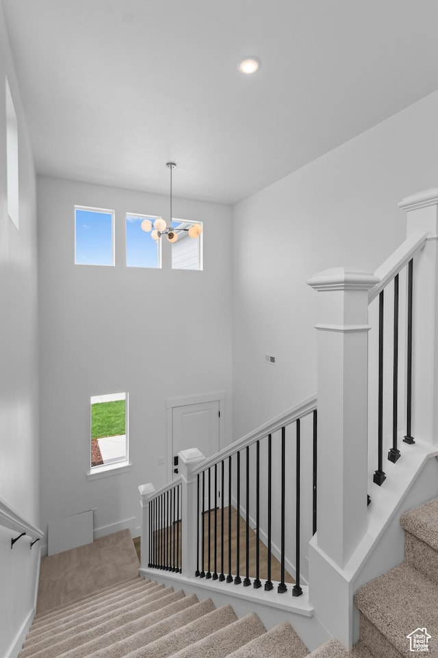688 N 600 W Unit 104, Tremonton, UT 84337 - staircase featuring a chandelier, plenty of natural light, recessed lighting, and carpet