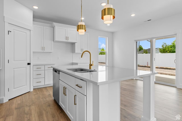 688 N 600 W Unit 104, Tremonton, UT 84337 - kitchen with light wood finished floors, tasteful backsplash, light countertops, dishwasher, and recessed lighting