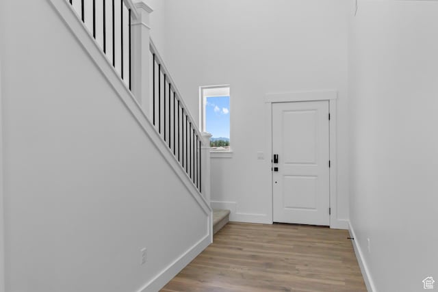 688 N 600 W Unit 104, Tremonton, UT 84337 - foyer featuring stairs, wood finished floors, and a towering ceiling