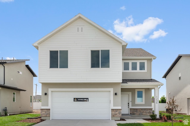 688 N 600 W Unit 104, Tremonton, UT 84337 - view of front facade with stone siding, a shingled roof, concrete driveway, a garage, and stucco siding