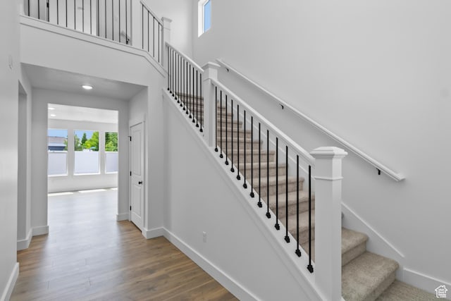 688 N 600 W Unit 104, Tremonton, UT 84337 - stairs with wood finished floors and a towering ceiling