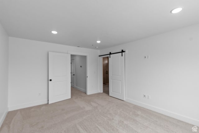 688 N 600 W Unit 104, Tremonton, UT 84337 - unfurnished bedroom featuring recessed lighting, light colored carpet, and a barn door