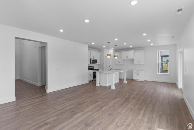688 N 600 W Unit 104, Tremonton, UT 84337 - unfurnished living room with recessed lighting and wood finished floors