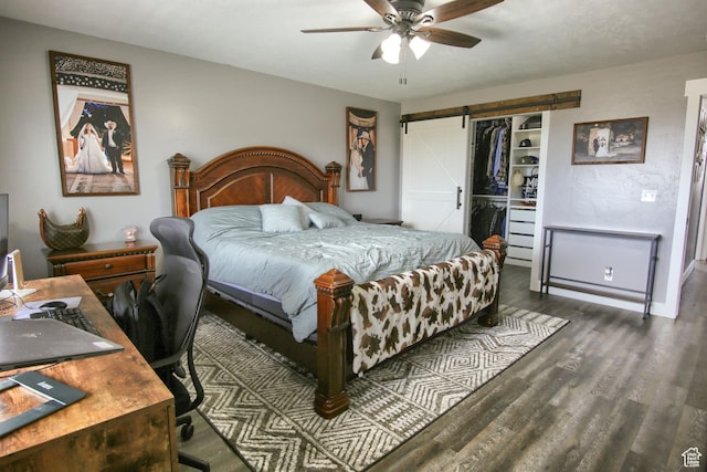 428 S Saddle Rd, Grantsville, UT 84029 - bedroom with dark wood-type flooring, a barn door, a ceiling fan, and a closet