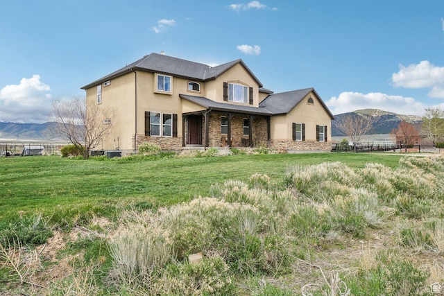 3214 W Ridgeline Rd, Stockton, UT 84071 - traditional-style house with fence, a mountain view, stucco siding, and stone siding