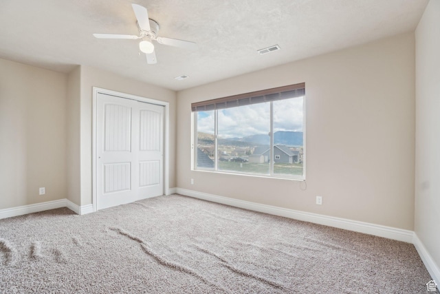 3214 W Ridgeline Rd, Stockton, UT 84071 - unfurnished bedroom with a closet, baseboards, carpet flooring, and visible vents