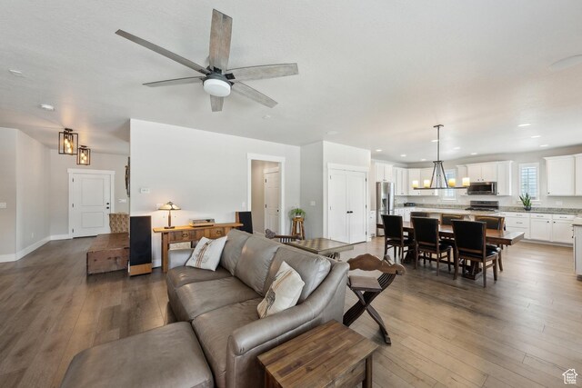 272 S 300 E, Midway, UT 84049 - living room featuring recessed lighting, wood-type flooring, ceiling fan with notable chandelier, and baseboards