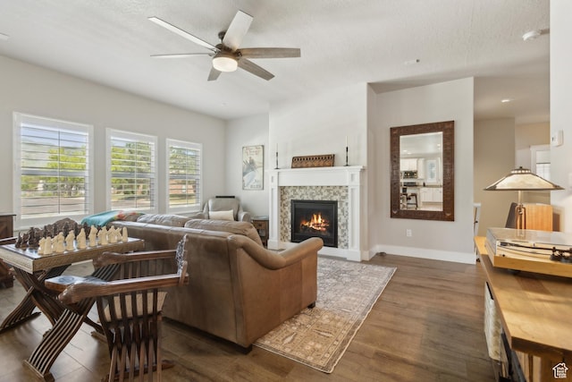 272 S 300 E, Midway, UT 84049 - living area with dark wood-style flooring, a ceiling fan, a fireplace, baseboards, and a textured ceiling