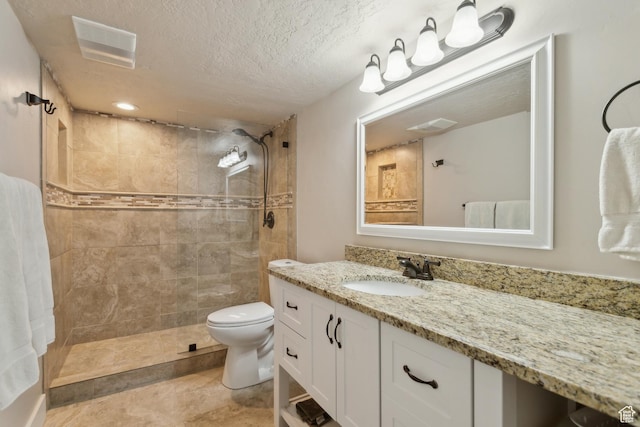 272 S 300 E, Midway, UT 84049 - bathroom with vanity, a tile shower, toilet, and a textured ceiling