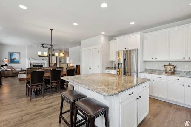 272 S 300 E, Midway, UT 84049 - kitchen with ceiling fan, light wood-style floors, open floor plan, a kitchen island, and stainless steel refrigerator with ice dispenser