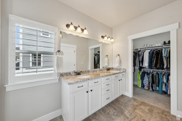272 S 300 E, Midway, UT 84049 - bathroom with double vanity, baseboards, a spacious closet, and a sink