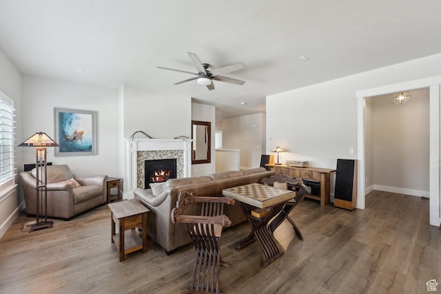 272 S 300 E, Midway, UT 84049 - living area with a tiled fireplace, baseboards, a ceiling fan, and light wood finished floors