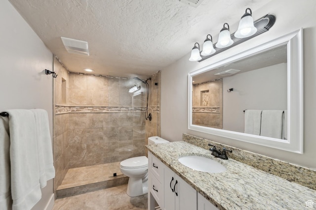 272 S 300 E, Midway, UT 84049 - full bathroom featuring a textured ceiling, visible vents, vanity, toilet, and tiled shower