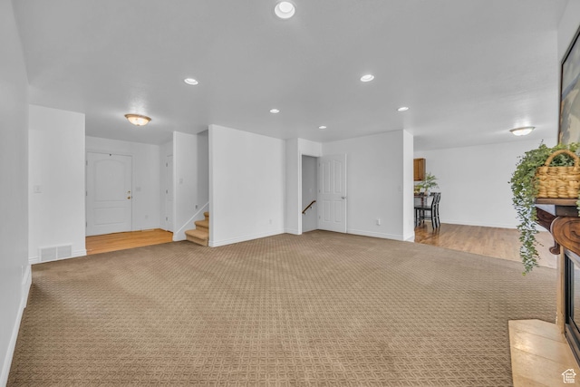 2948 W 150 N, Layton, UT 84041 - unfurnished living room featuring light carpet, recessed lighting, stairs, and baseboards