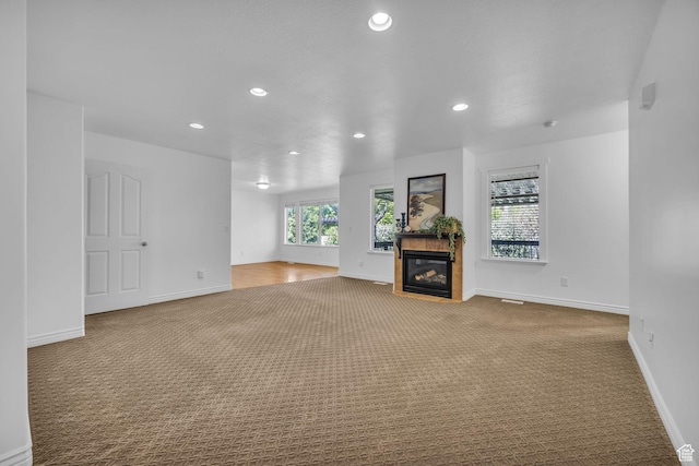 2948 W 150 N, Layton, UT 84041 - unfurnished living room with carpet floors, recessed lighting, a glass covered fireplace, and baseboards