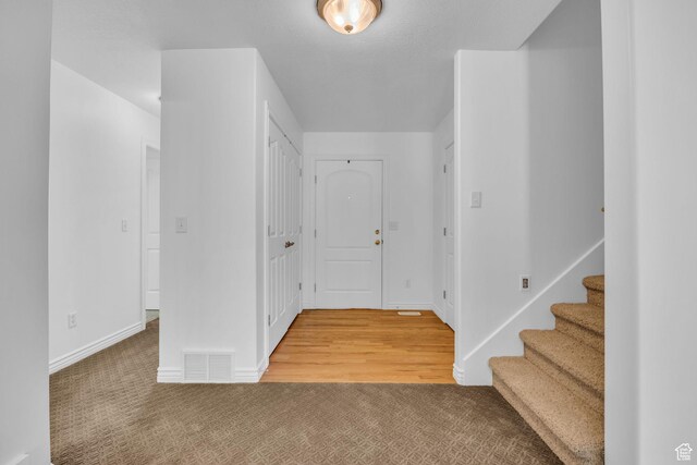 2948 W 150 N, Layton, UT 84041 - foyer entrance featuring light carpet, baseboards, and stairs